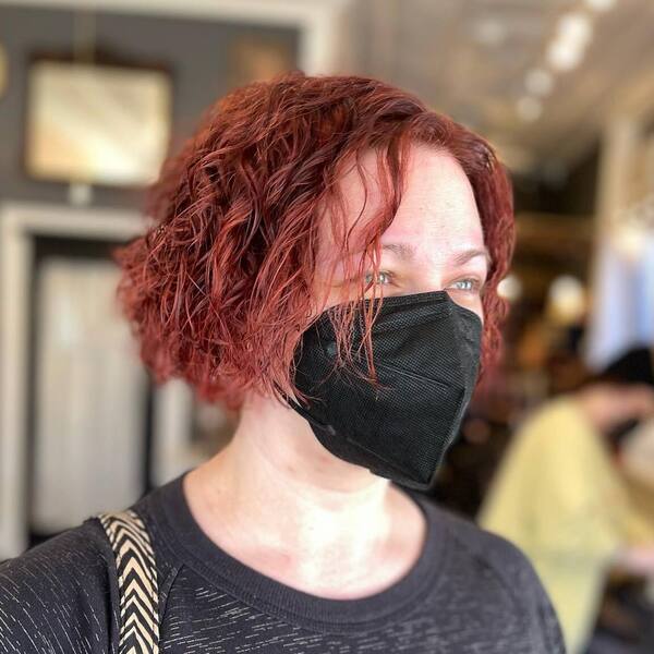 Reddish Brown Cut Curl Bob - a woman wearing mask and black shirt.