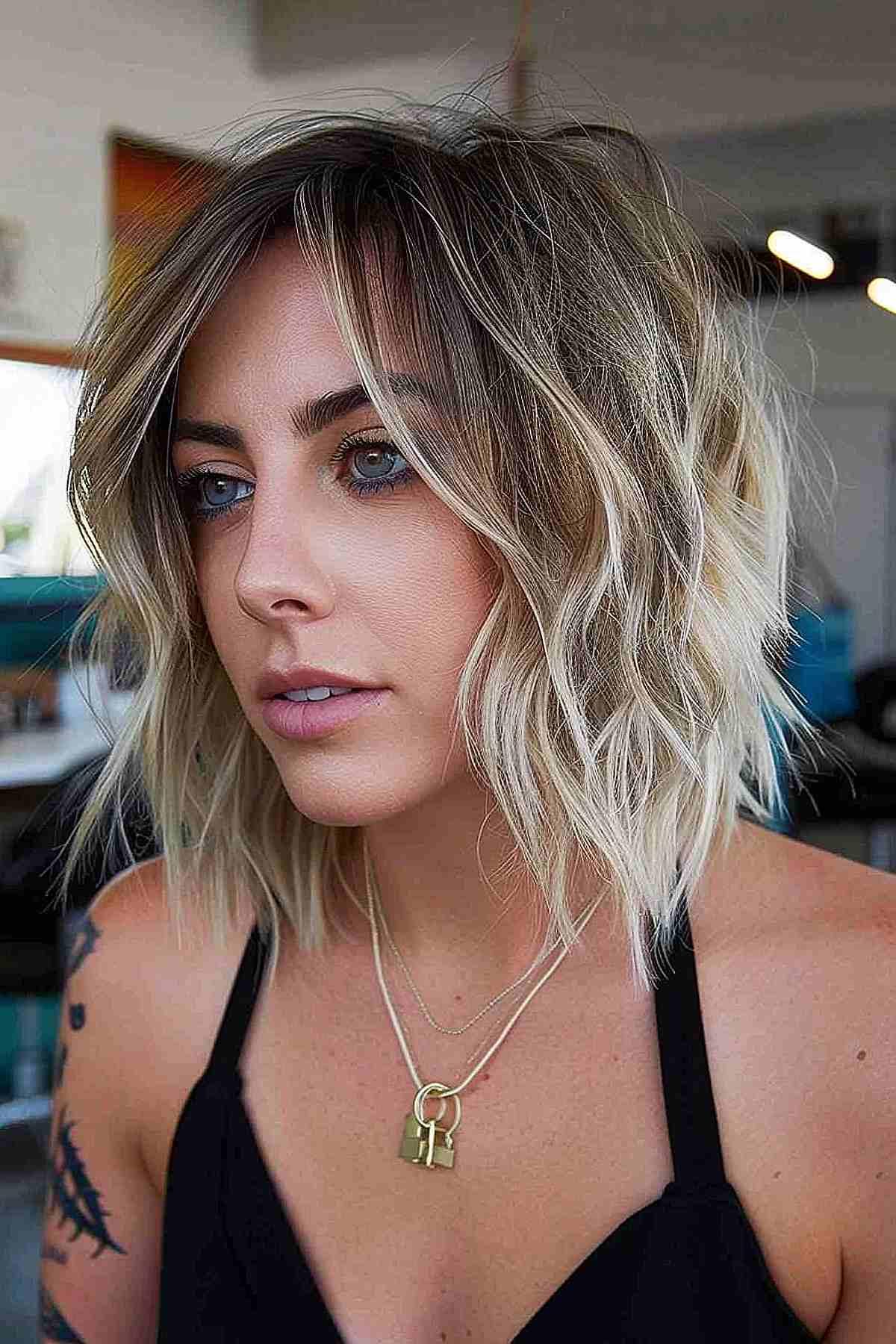 Short platinum blonde bob with textured shaggy layers.