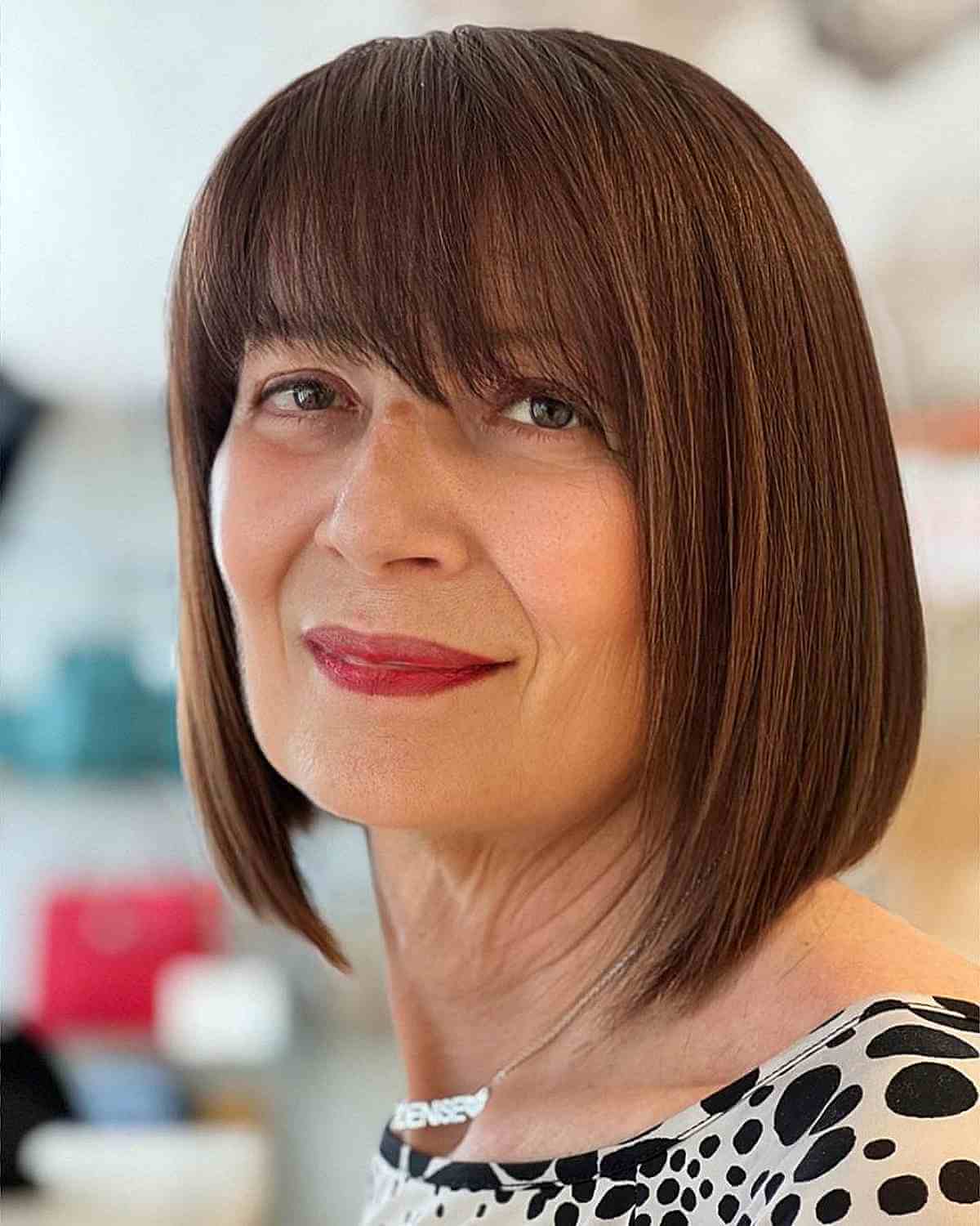 Sleek Brunette Bob with Wispy Bangs for 50-Year-Old-Women