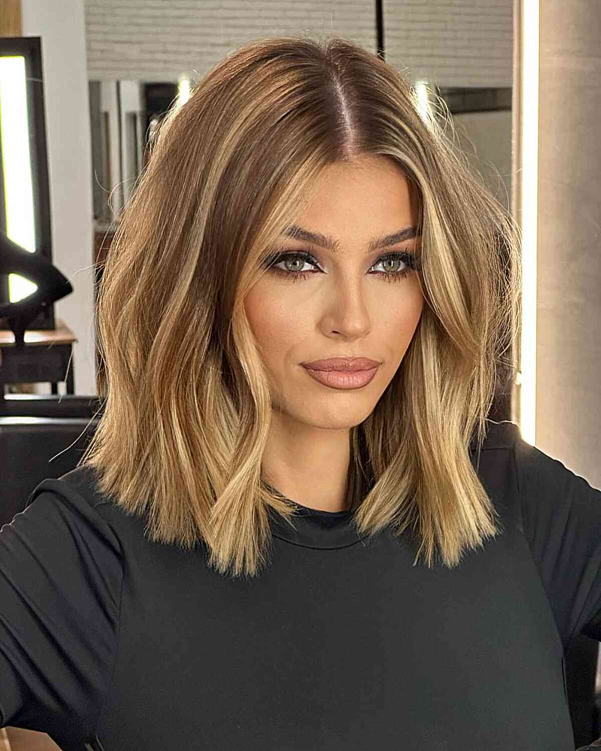 Warm Blonde Color on a Shoulder-Length Blunt Bob Cut