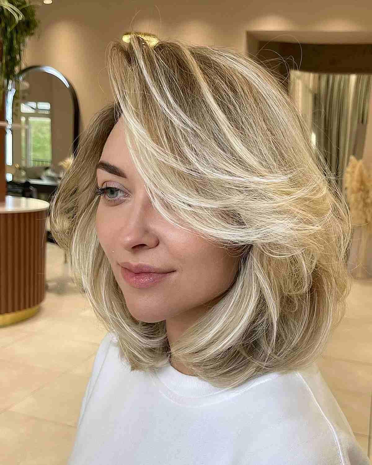 Feathered Blonde Bob with a Deep Side Part