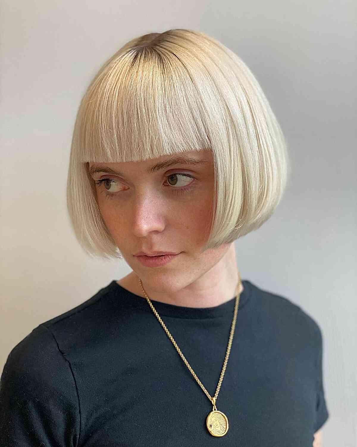 Jaw-Length Sharp Edges on a Bob with Bangs for women with thick blonde hair