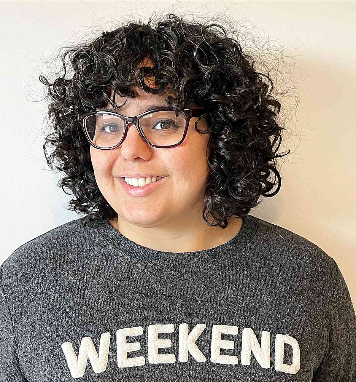 Neck-Length Shagged Curly Bob with Curly Bangs for Round Faces