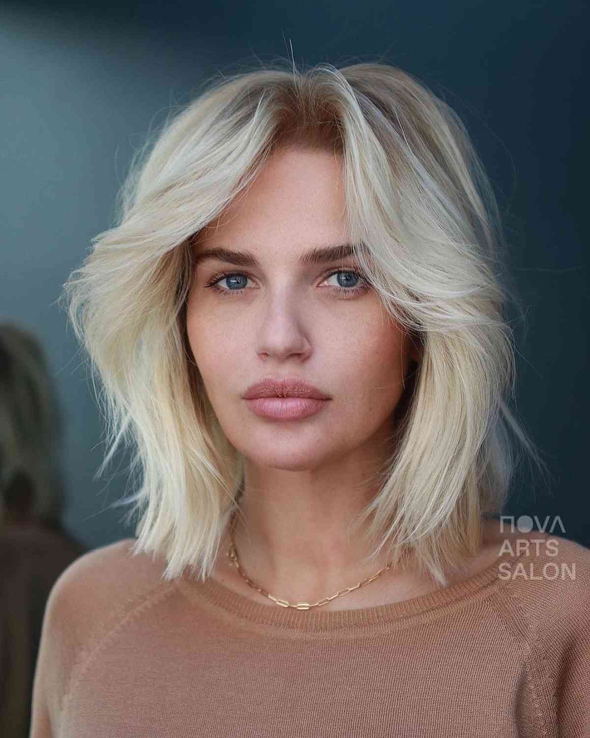 Shaggy Blonde Bob with Layers and Curtain Bangs 