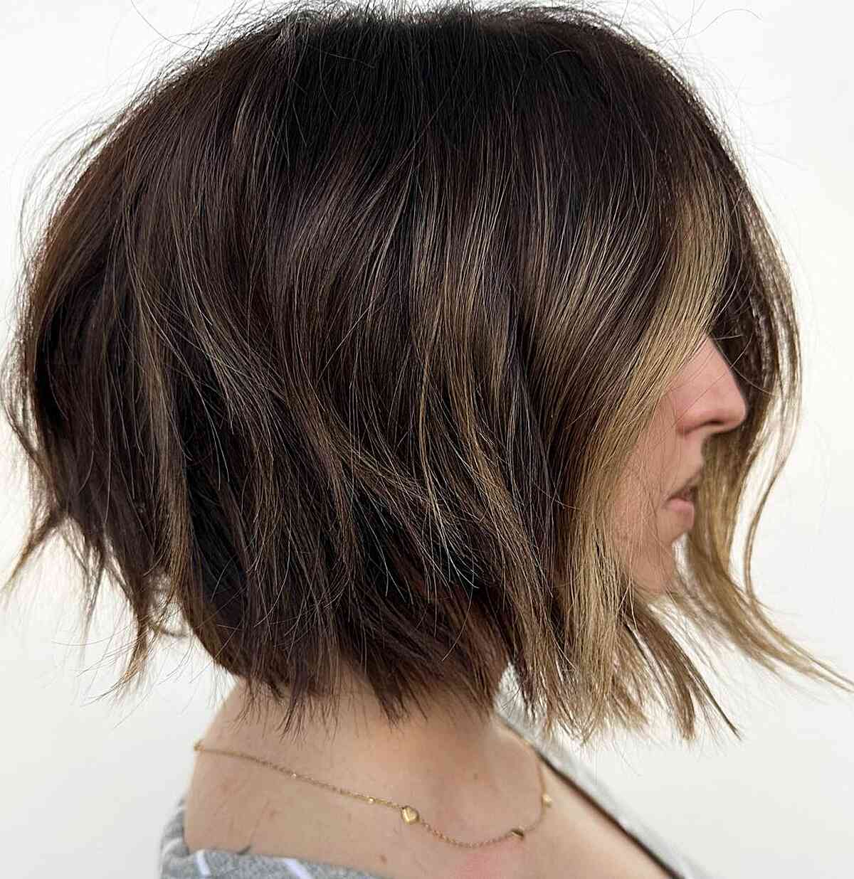 short, choppy bob with Lots of Volume and blunt ends with a money piece