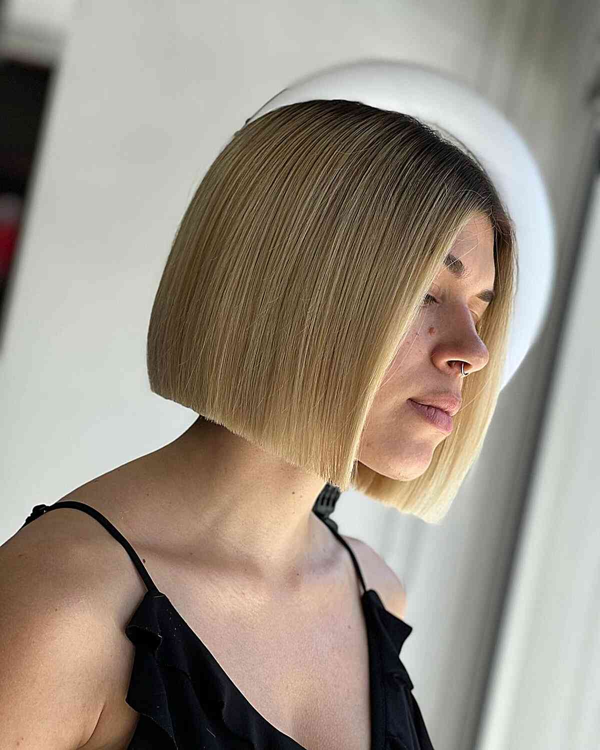 Short Sleek Slob Cut Bob with Full Blonde Highlights and Dark Roots