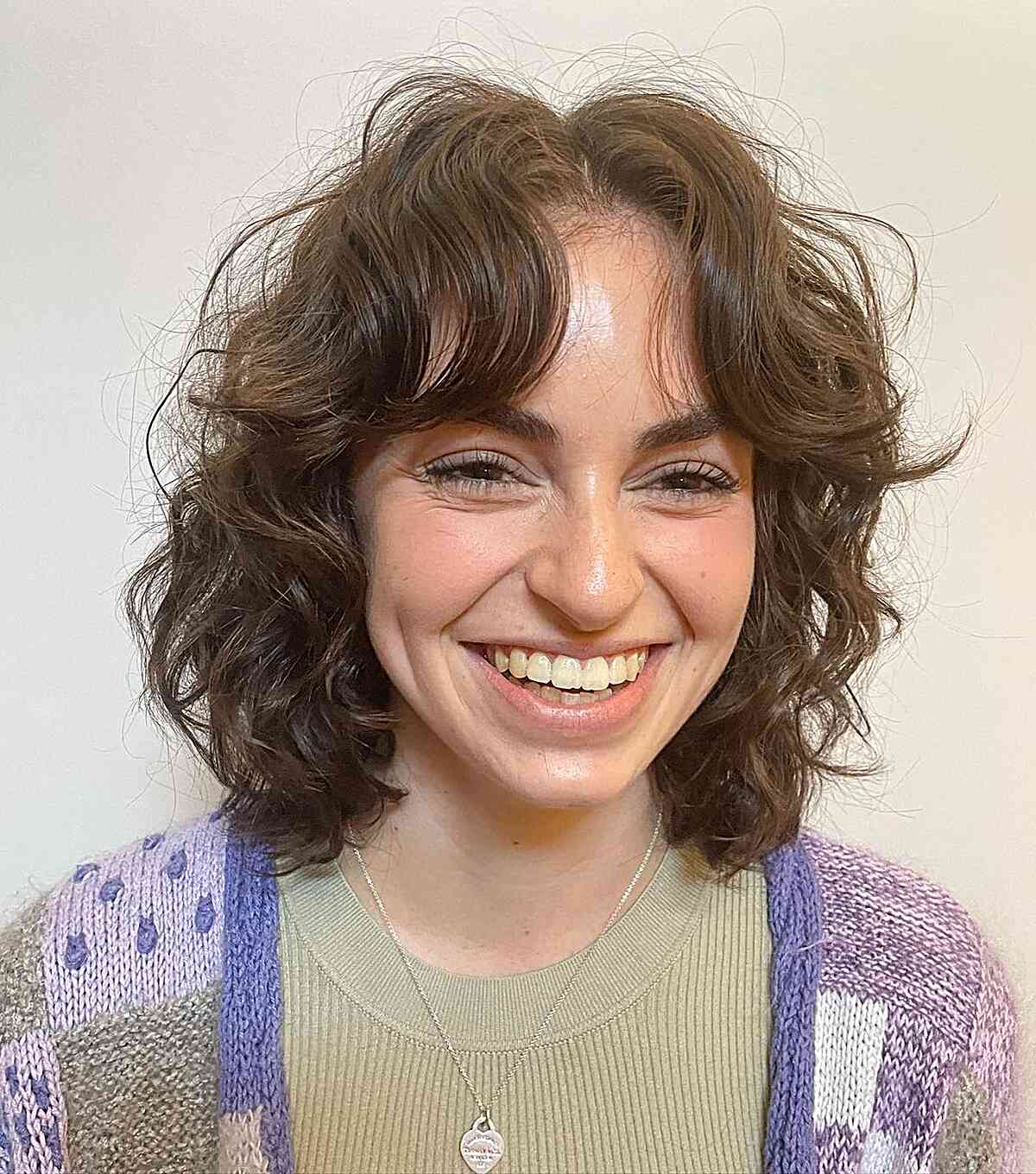 Shoulder-Length Layered Face-Framing Curly Bob with Airy Bangs