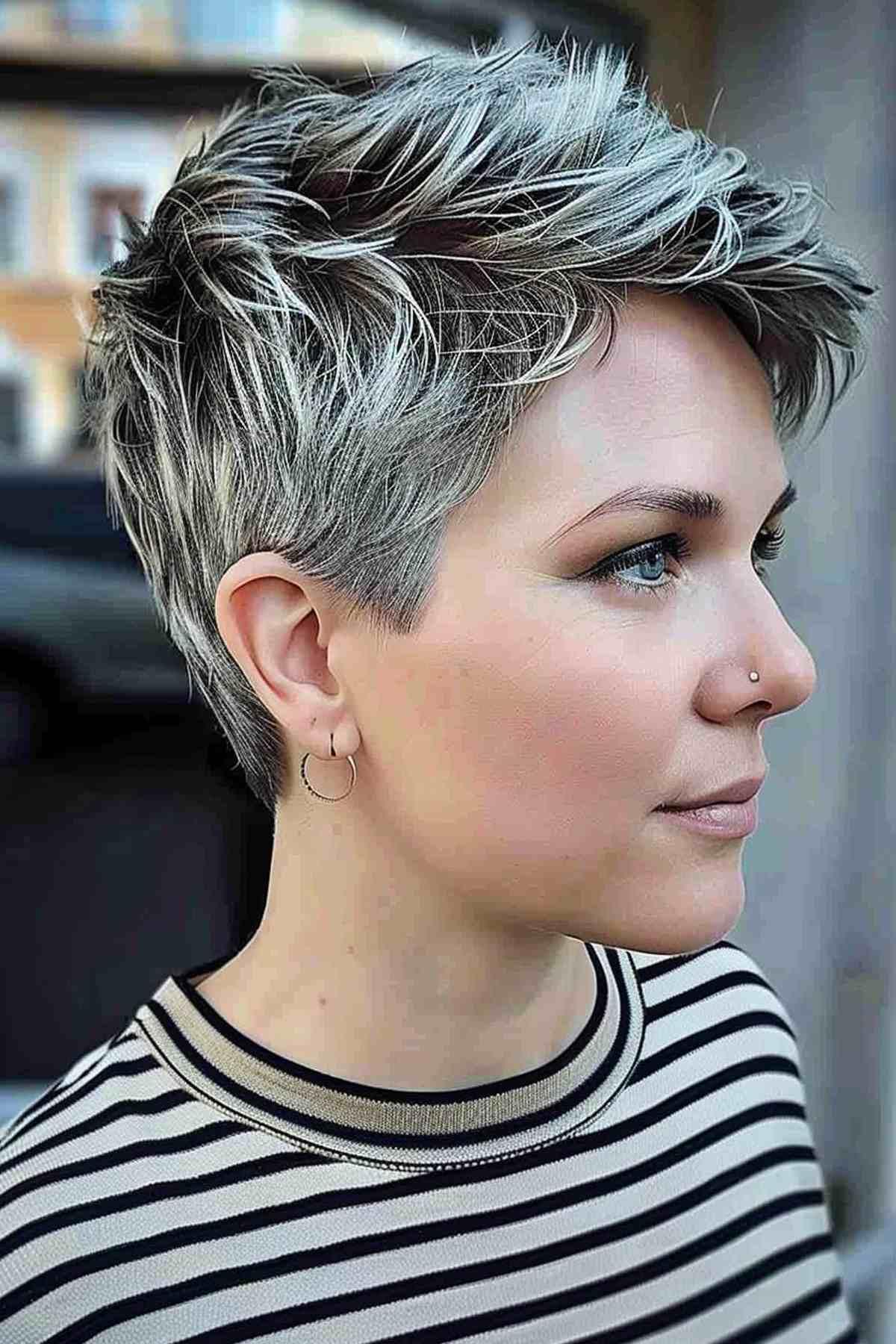 Side view of a stylish very short pixie cut with textured layers.