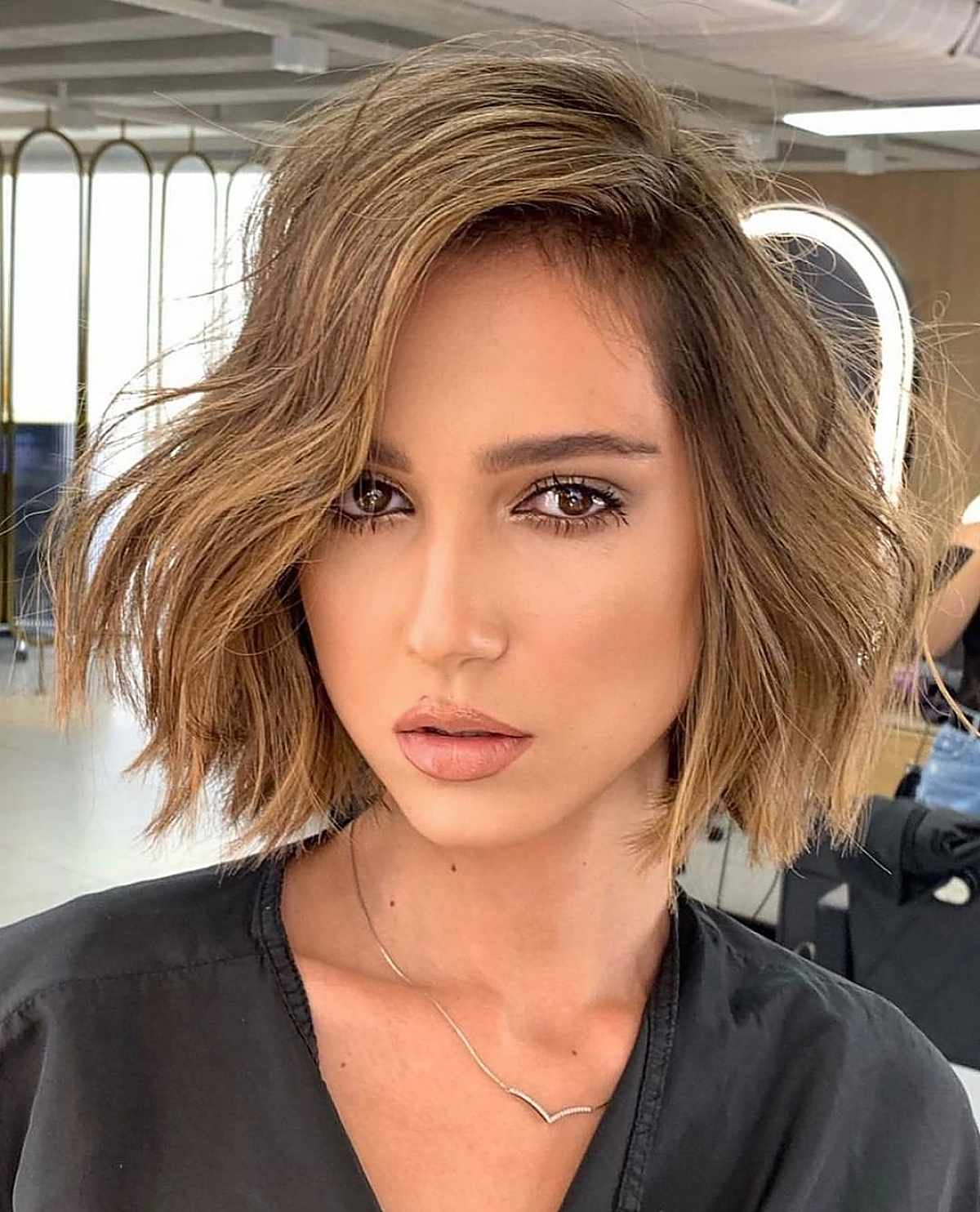 Textured deep side part bob haircut