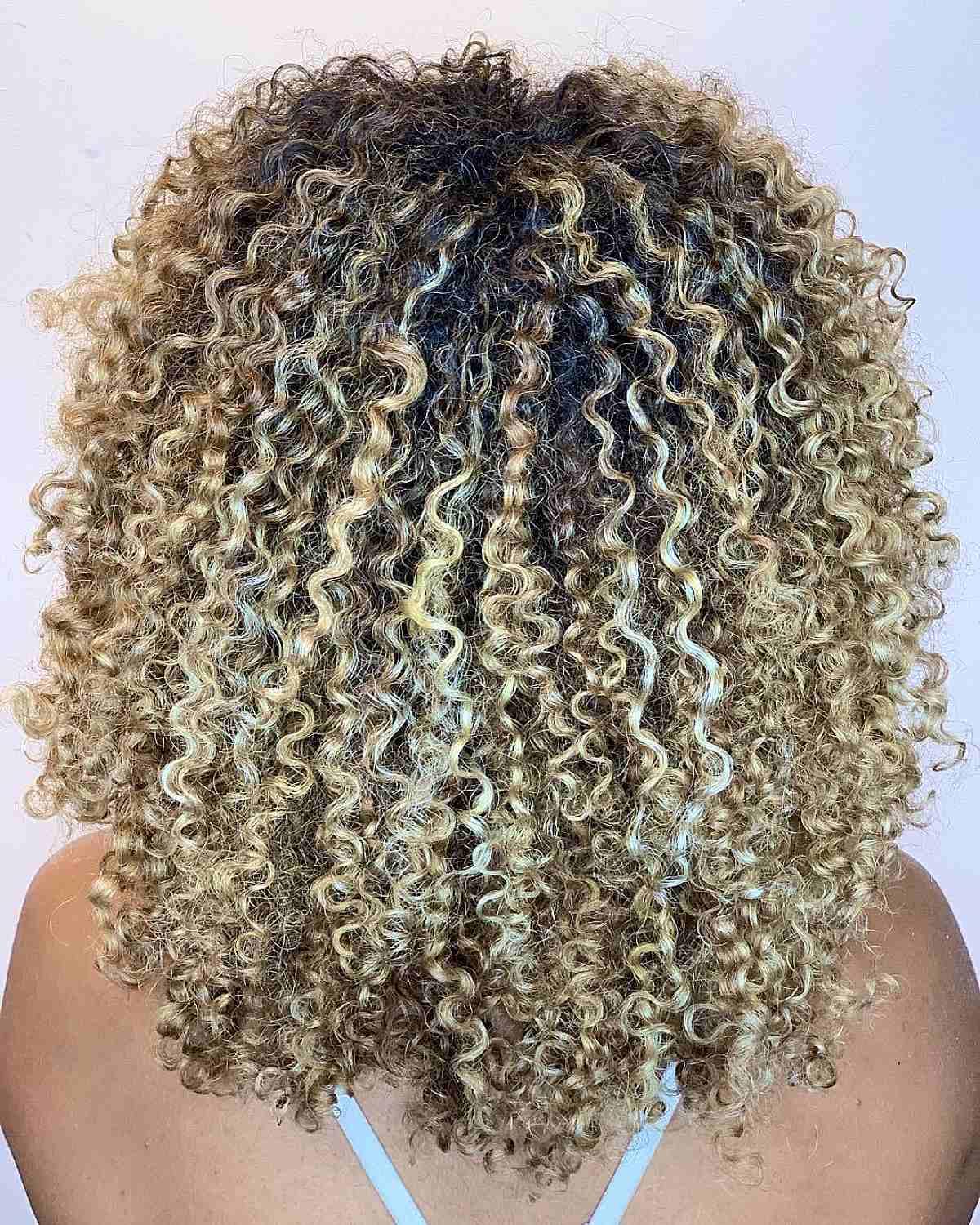 Balayage Spiral Curls with Medium Blonde Highlights