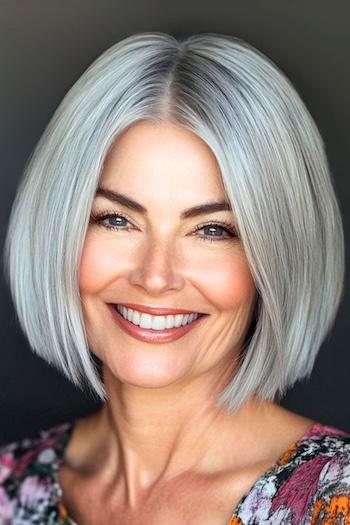 Blunt Bob with Razor-Cut Ends Haircut on a smiling woman with gray hair.