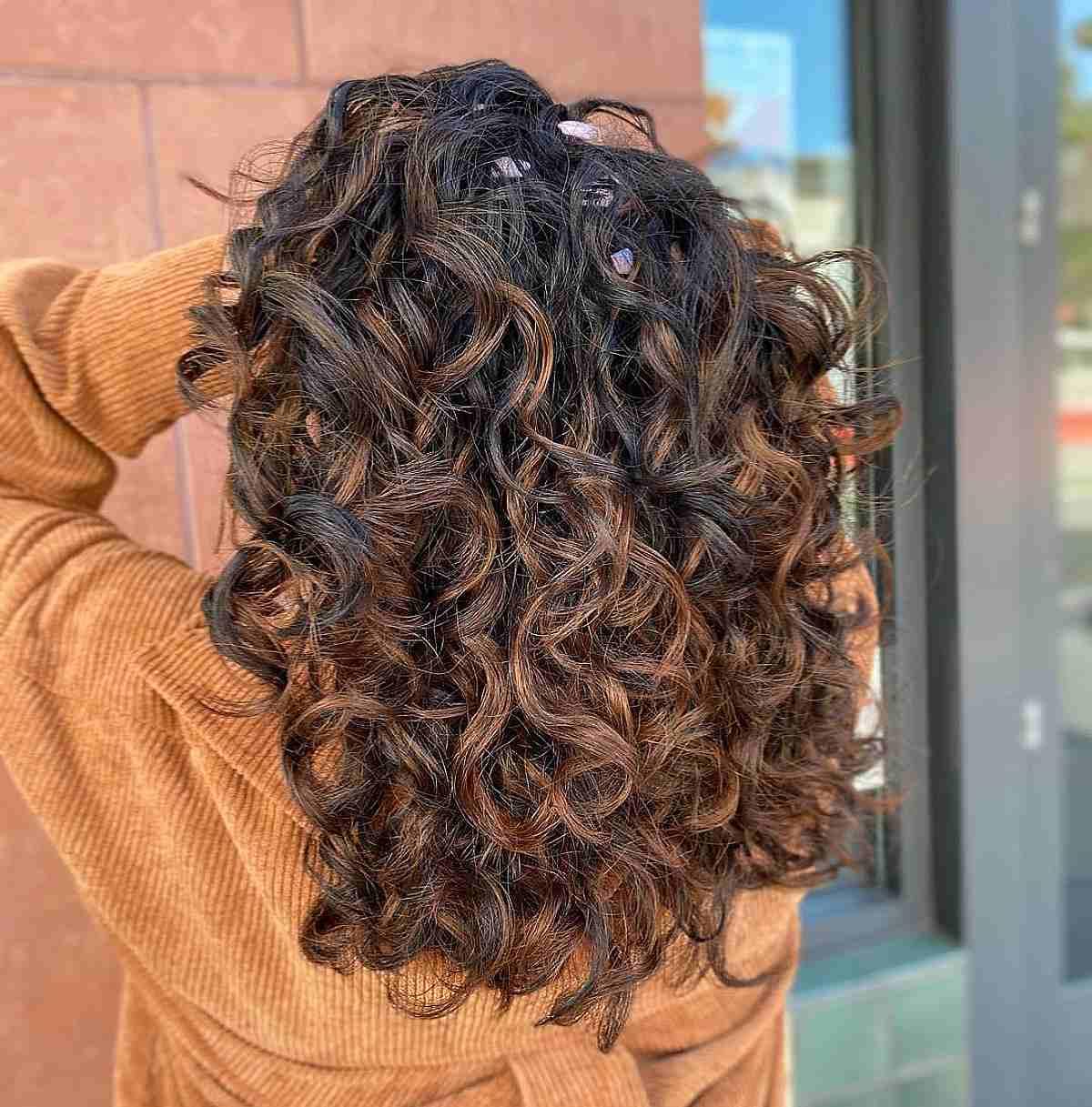 Deep Copper Streaks on Curly Black Balayage Hair