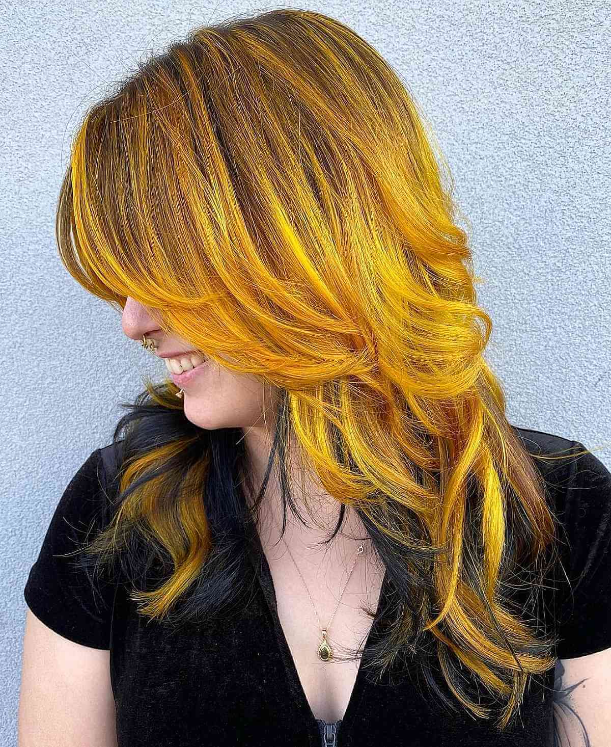 layered hair with a mix of yellow and black color