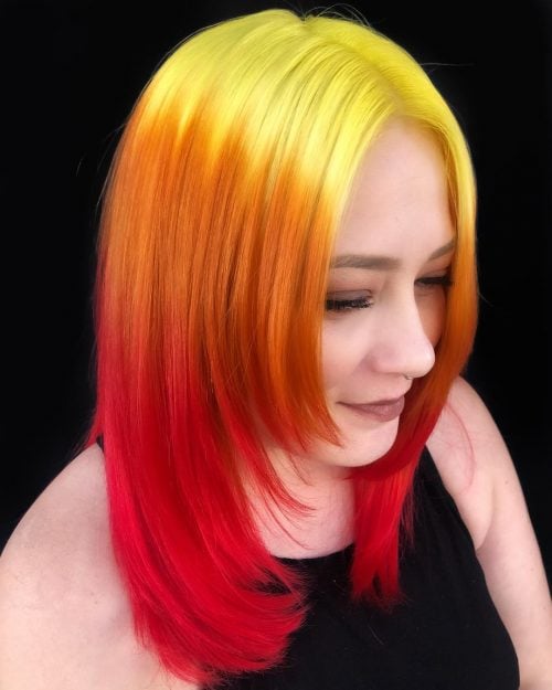 Medium length layered cut with yellow to orange to red color