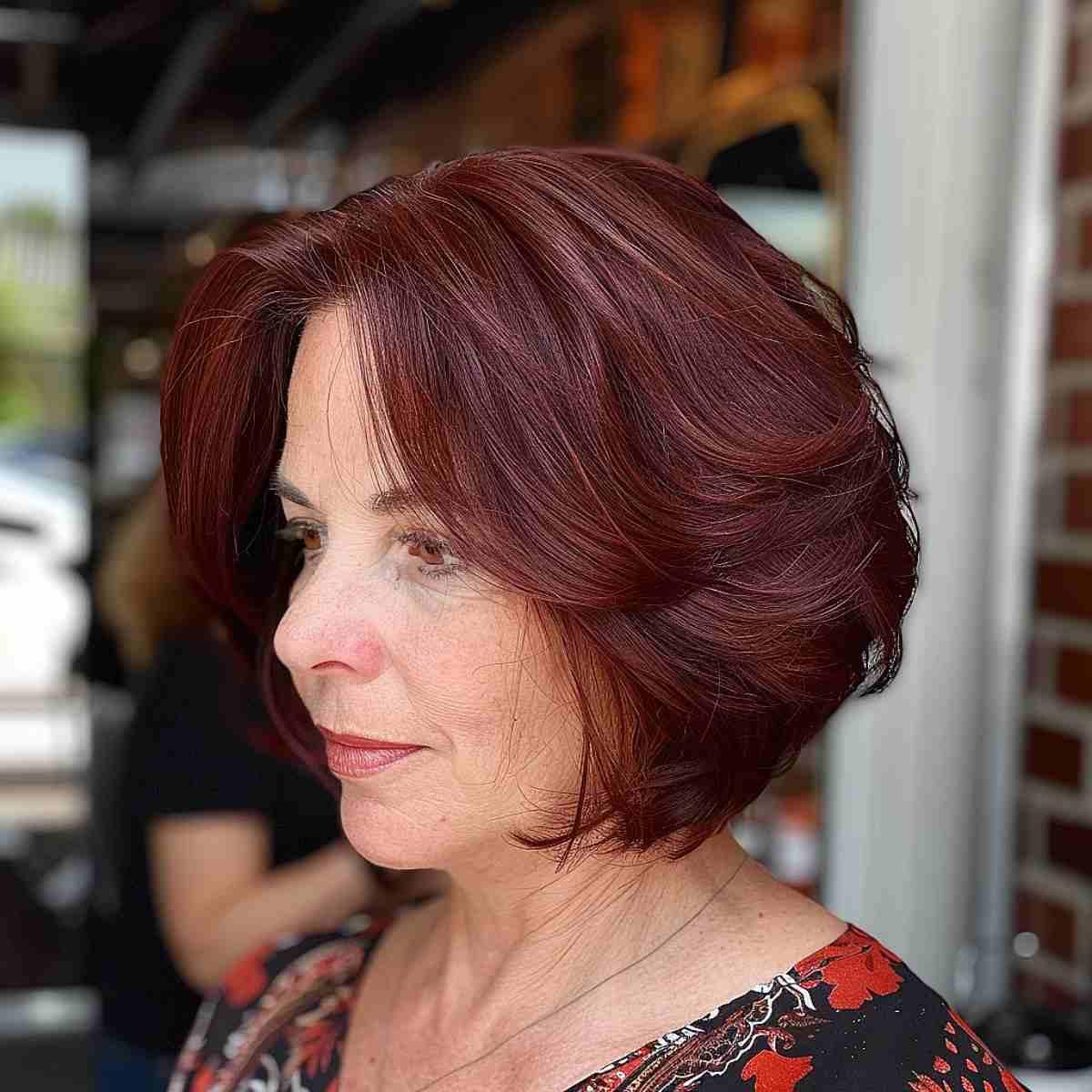 Short maroon-burgundy bob for women over 50