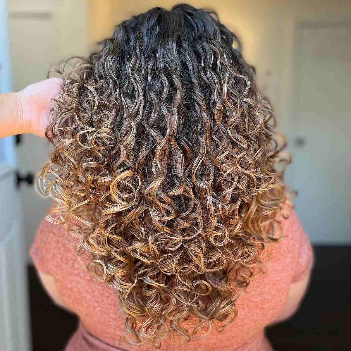 V-Cut Bronde Curls on Balayage Dark Hair