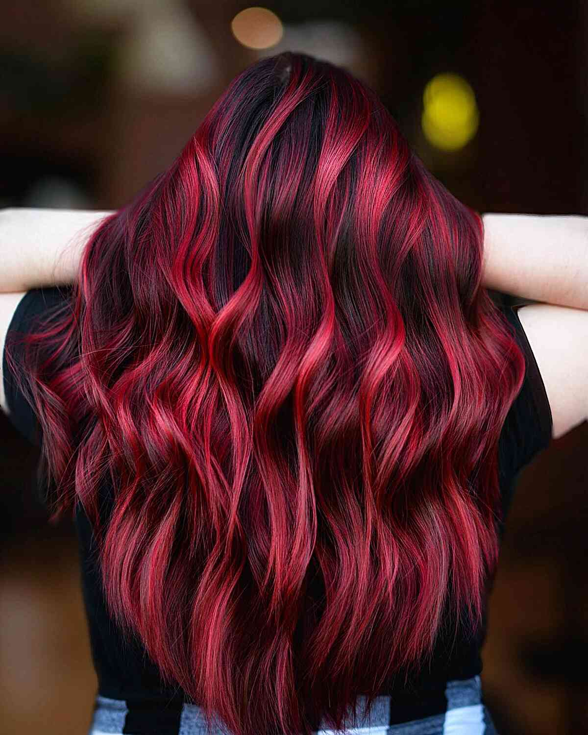 Cherry Red Balayage Highlights on Black Hair for women with long wavy hair