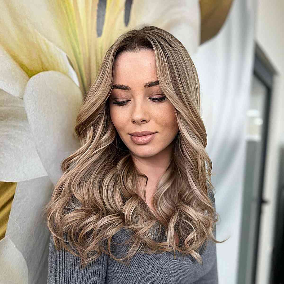 Dark Rooted Curled Dark Blonde Hairstyle with layers and a center part