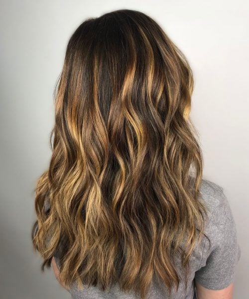 Dimensional honey balayage highlights on dark brown hair