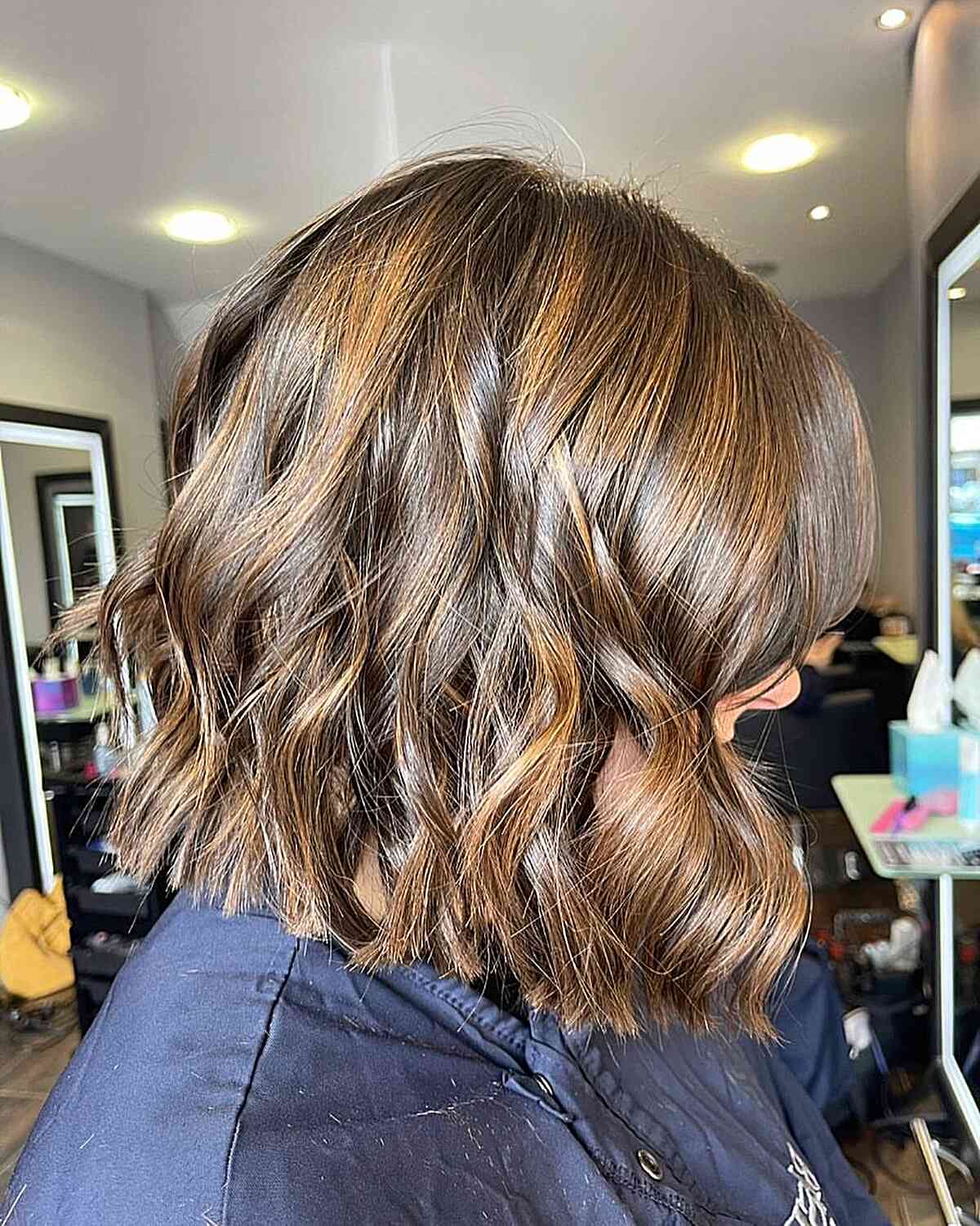 Gold Brown Balayage on a Shoulder-Length Wavy Blunt Bob