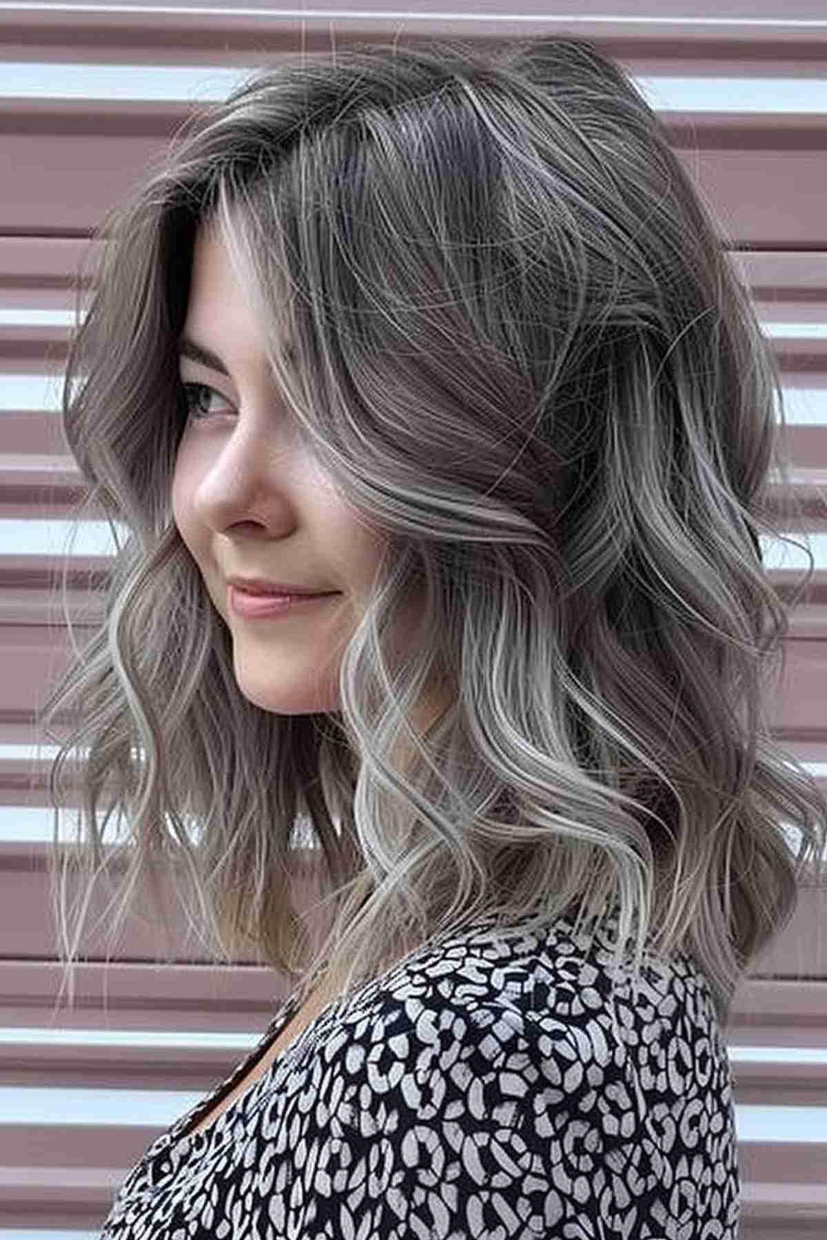 Medium-length wavy bob with natural-looking silver babylights and darker roots