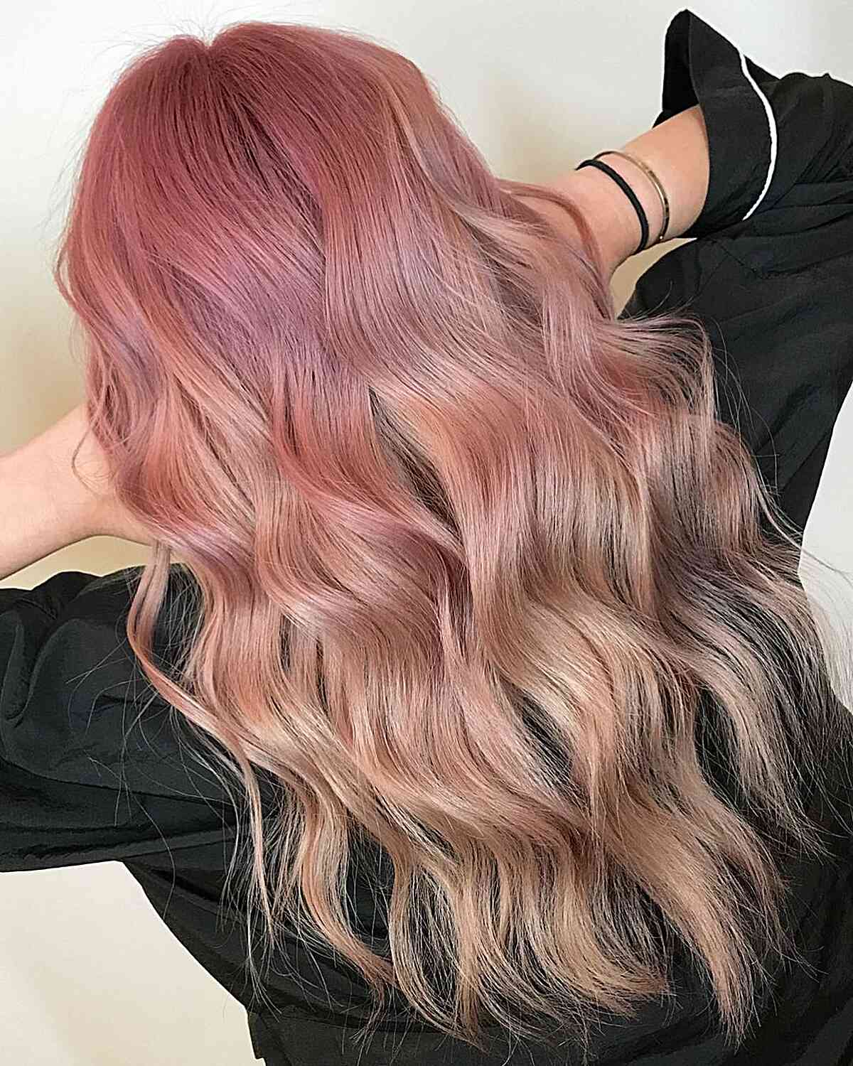 Pink Lemonade Balayage on long wavy hair with wispy ends