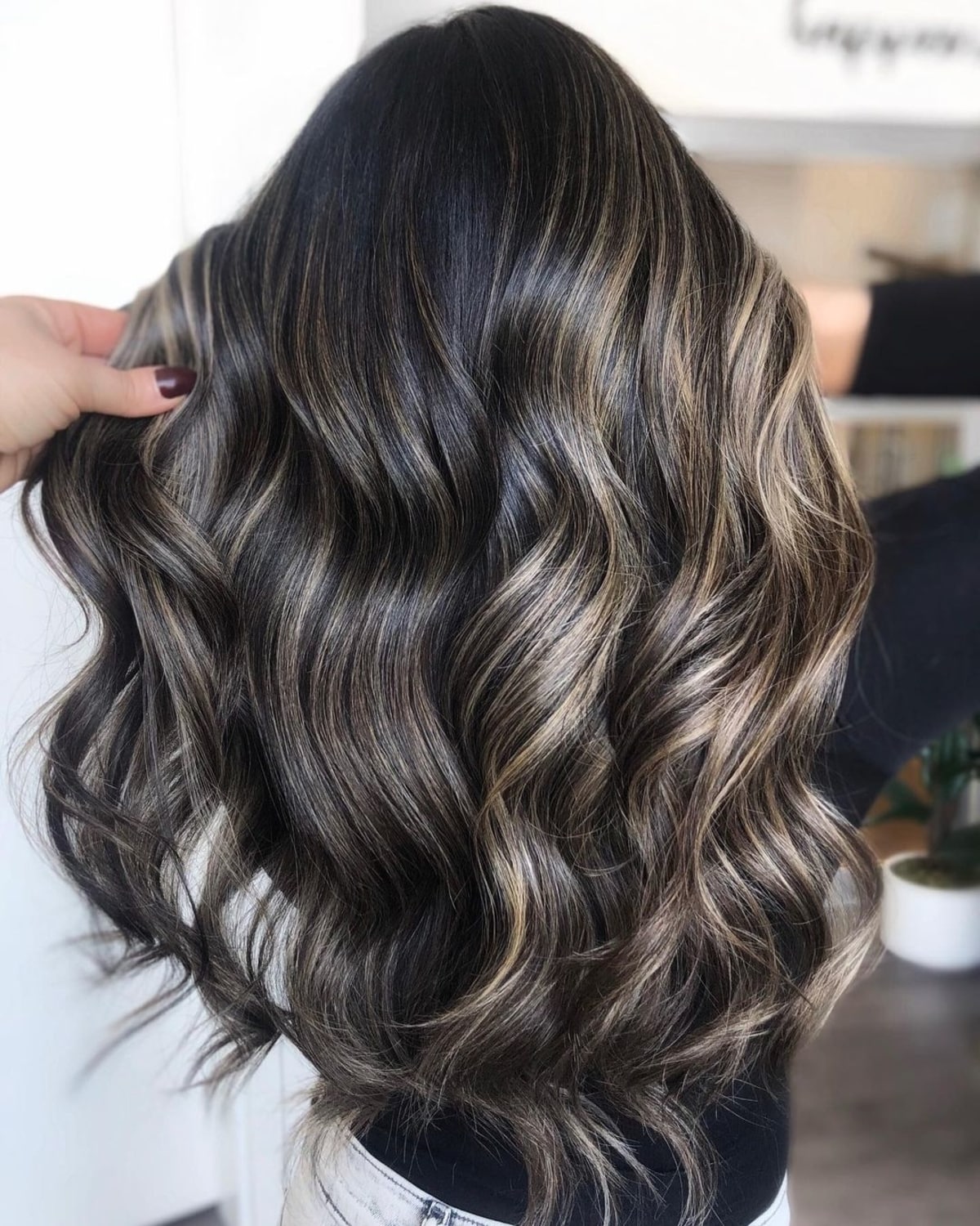 Sun-kissed balayage highlights on black hair