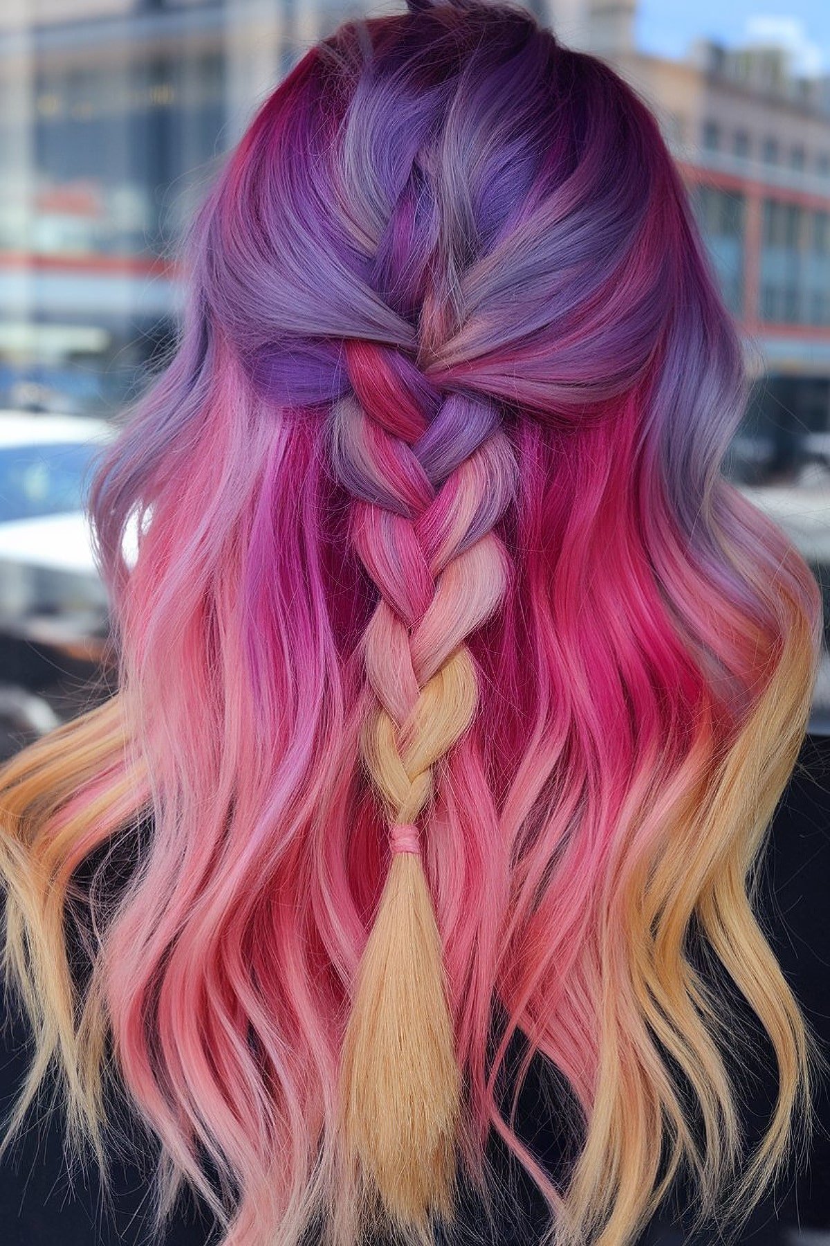 This stunning blend of purple, pink, and blonde perfectly captures the magic of fall with a fun Halloween twist. The loose braid adds dimension and helps the colors stand out, making this look perfect for medium to long hair with natural waves. Great for someone wanting a playful, yet elegant fall-inspired style.