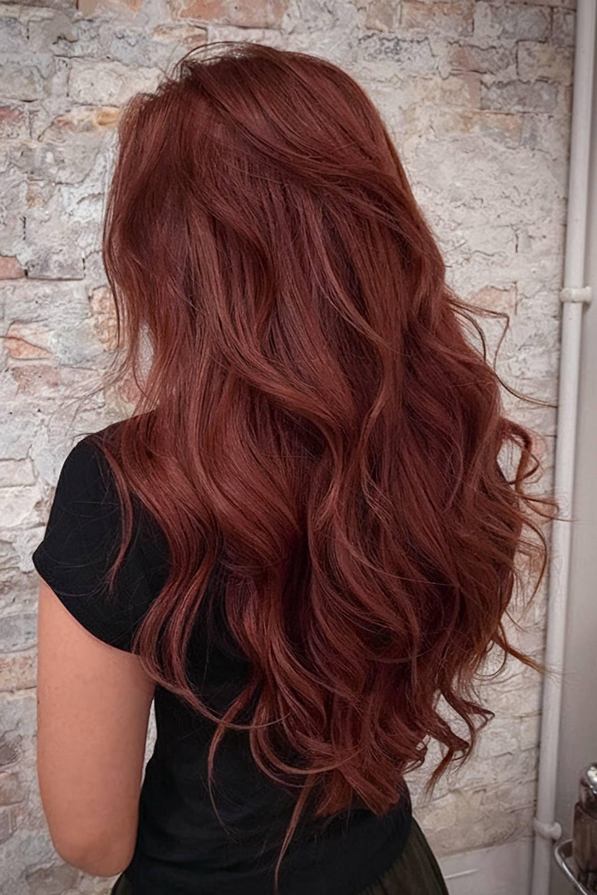 Cherry wine hair color on long wavy hair