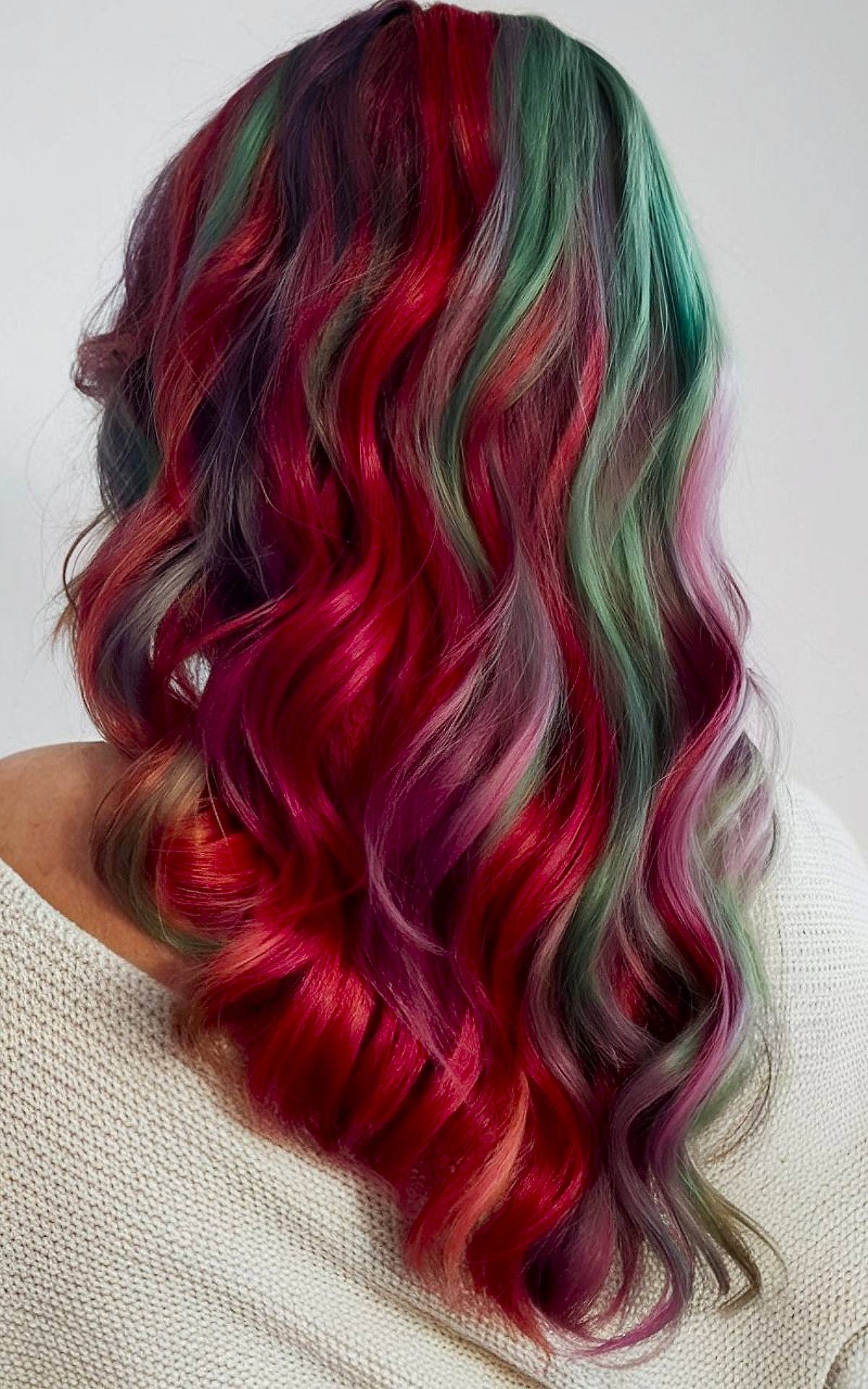 Christmas hair color idea with wavy red, green, and purple layers