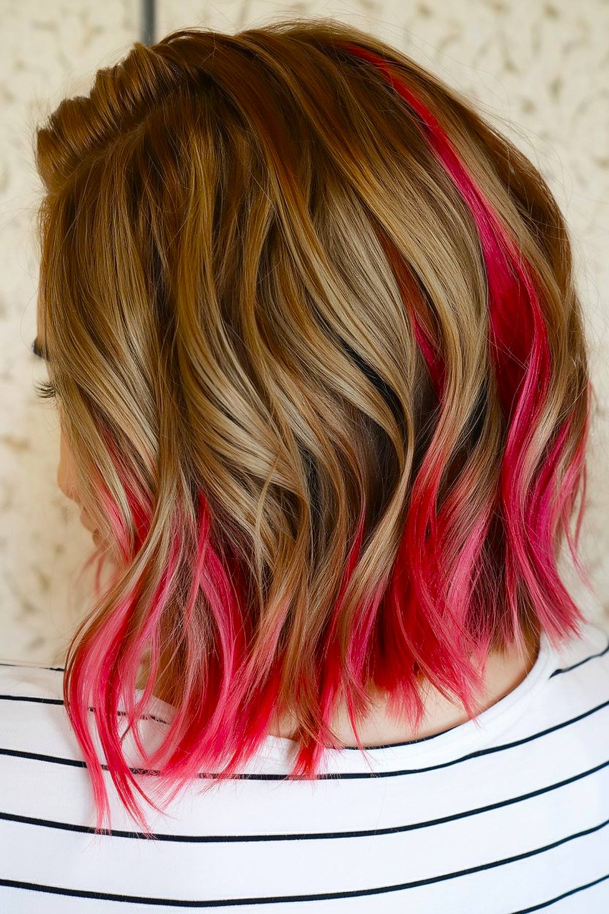 Christmas peekaboo hair color idea with caramel waves and pink highlights