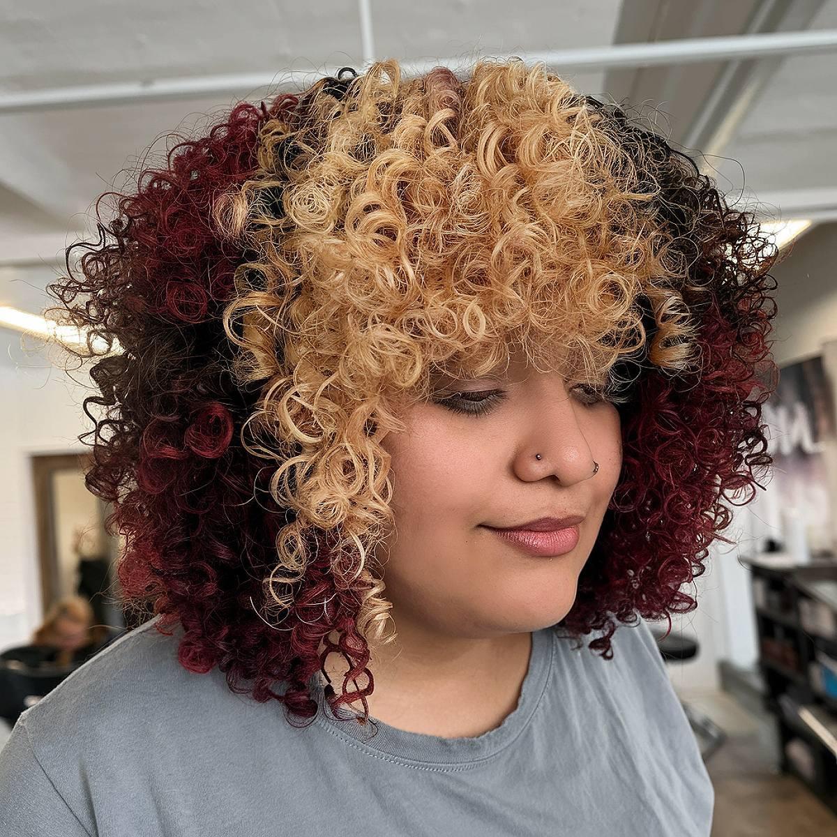 Curly calico hair color with copper and honey blonde