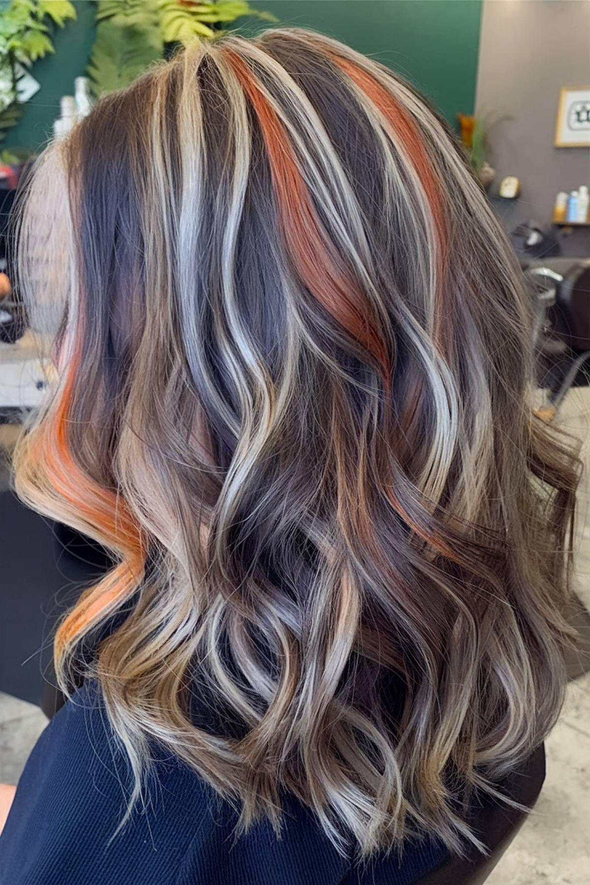 Dark calico hair color with blonde and orange streaks