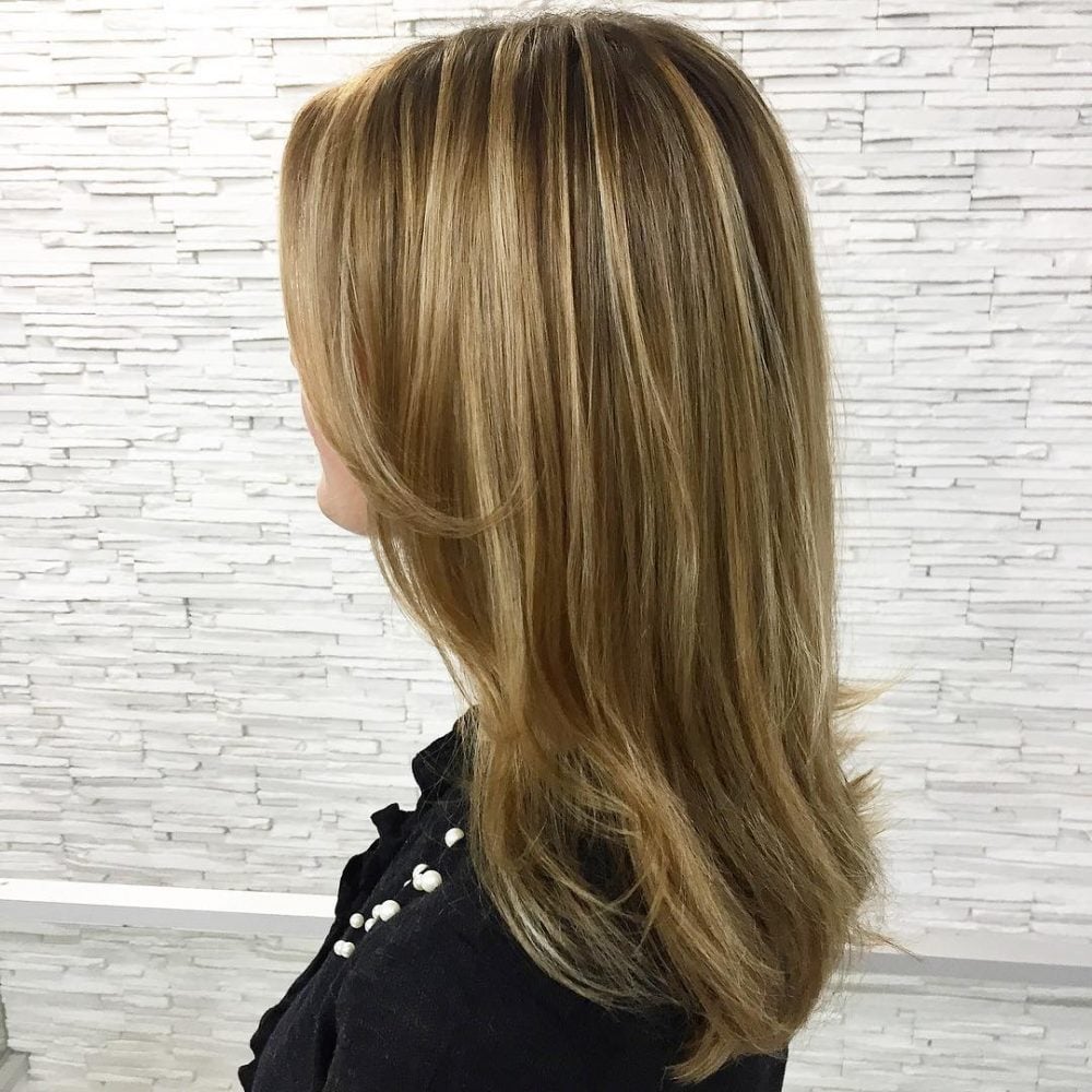 Flattering honey blonde balayage for straight hair