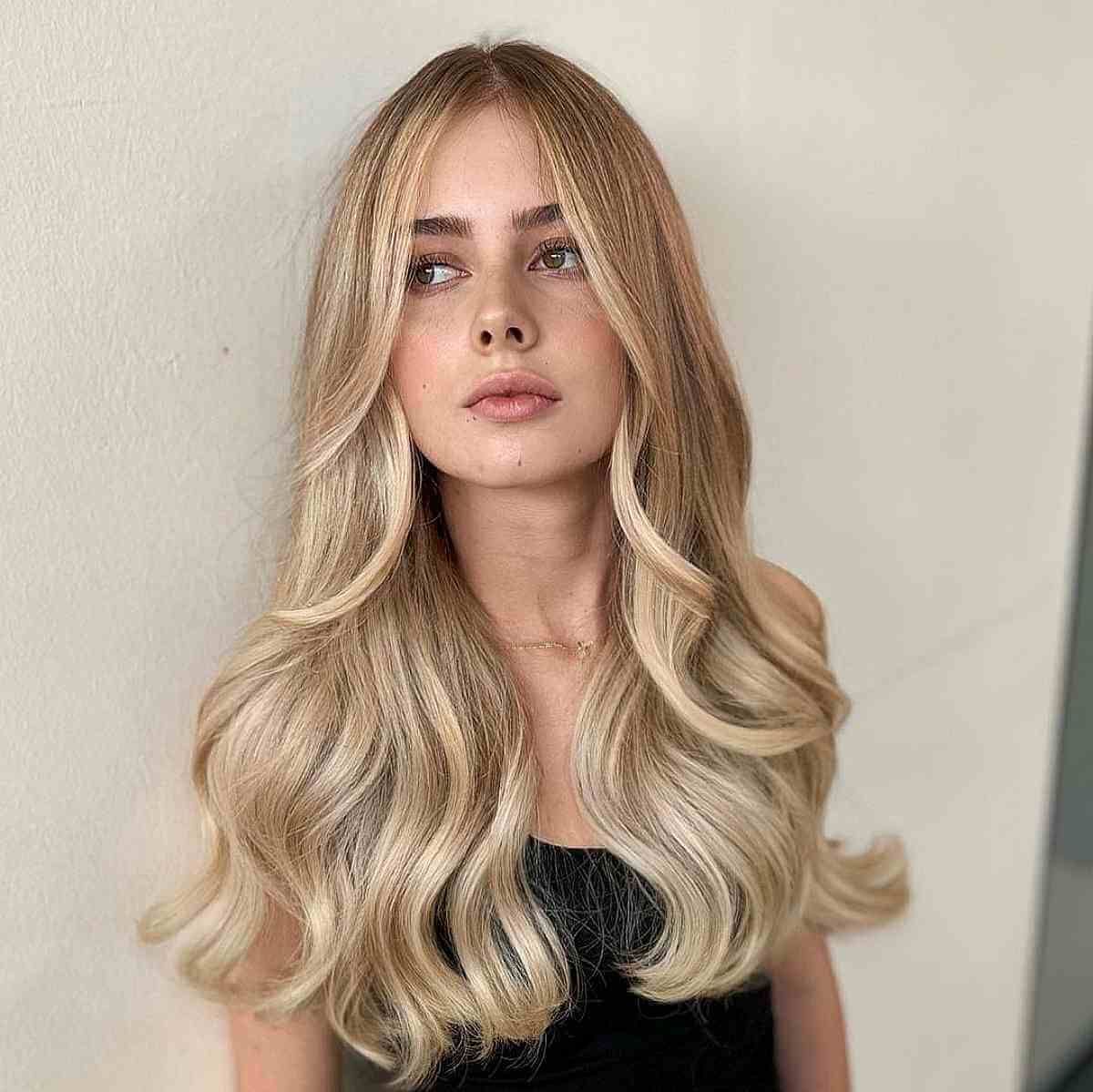 Long Blonde Balayage with Long Curtain Bangs