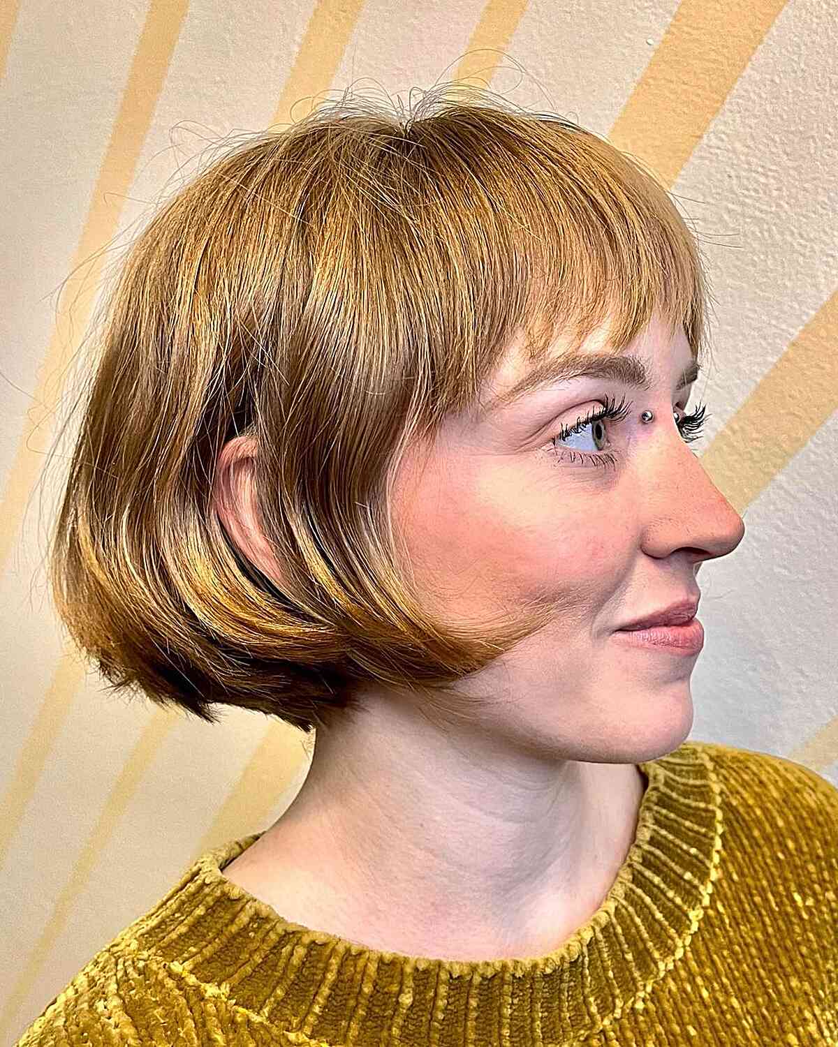 Trendy Honey Blonde Ear-Length Bob with Bangs