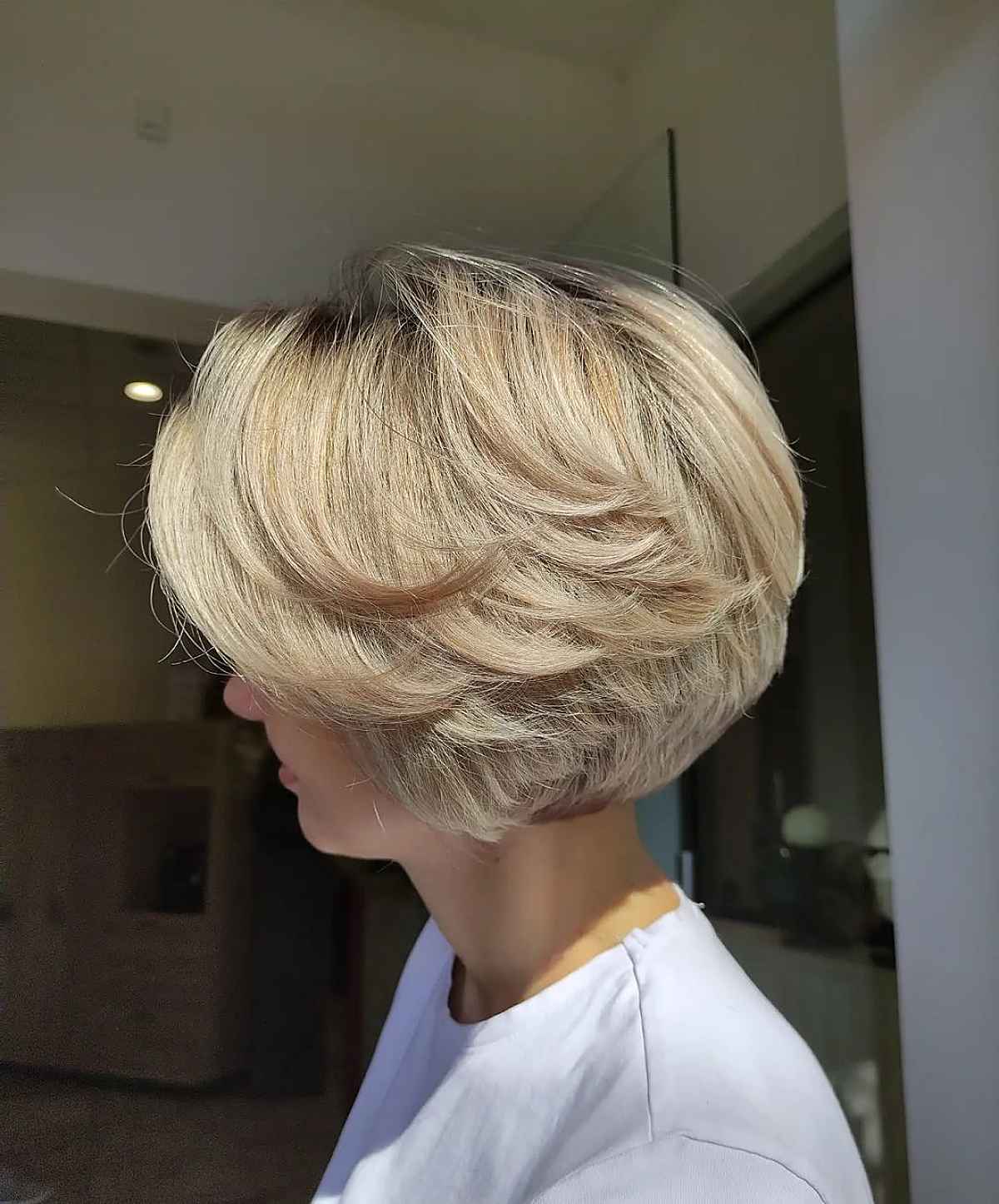 warm blonde feathered bob cut